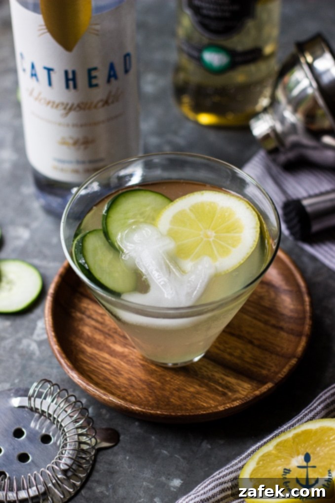 The Purring Blur 4 Close-up of The Tipsy Cat cocktail, highlighting the fresh cucumber and lemon garnishes.