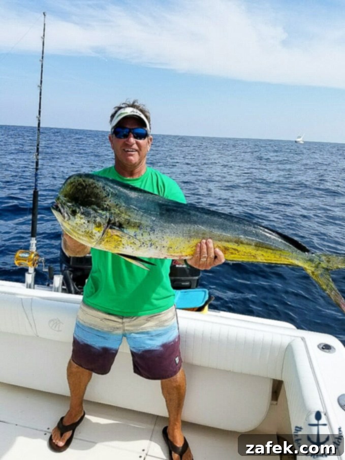 Savory Grilled Mahi Mahi and Veggie Foil Bundles 5 Proud Fisherman Joey Holding a Large, Freshly Caught Mahi Mahi Fish