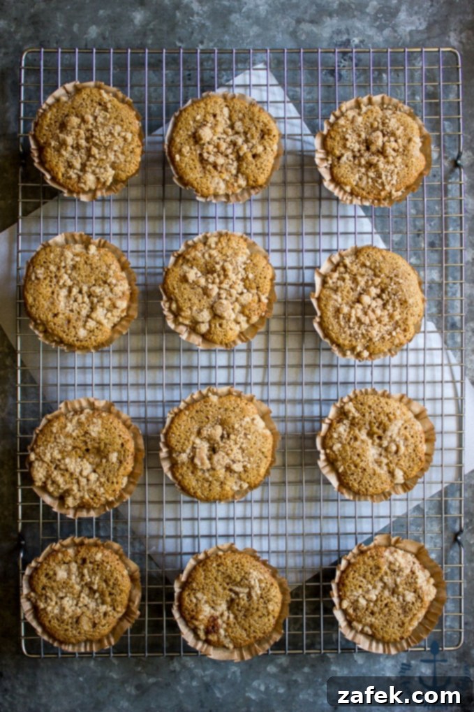 A tray of Apple Spice Crumb Muffins with a dusting of glaze