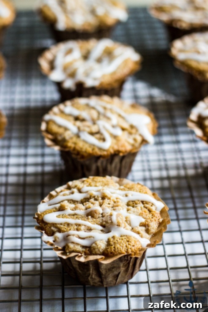 Stacks of Apple Spice Crumb Muffins on a rustic board