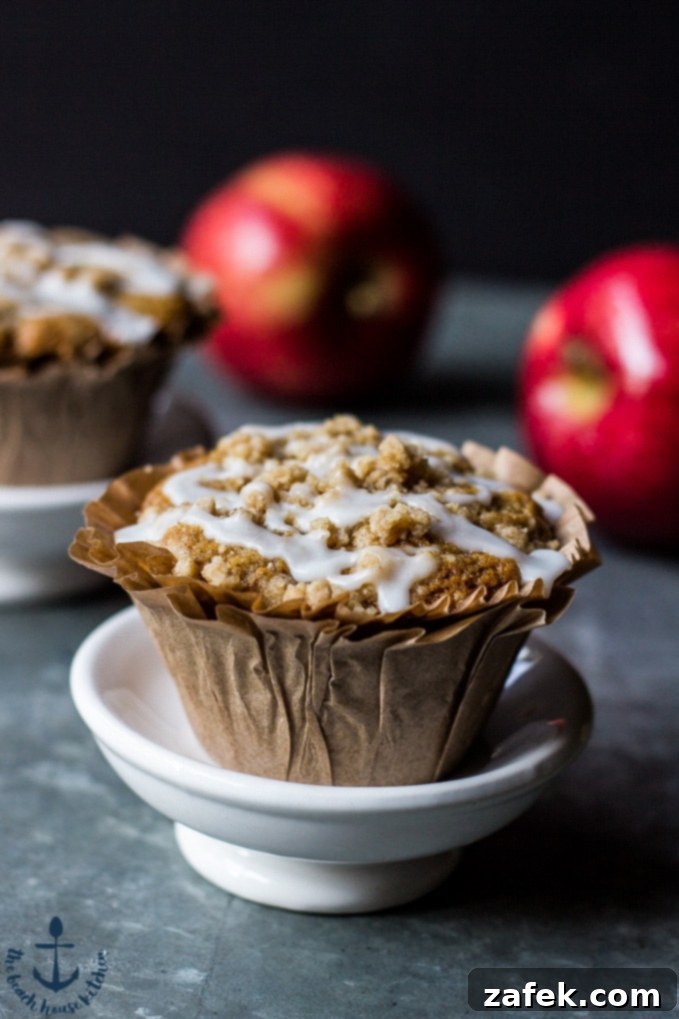 An Apple Spice Crumb Muffin cut open to reveal its moist interior