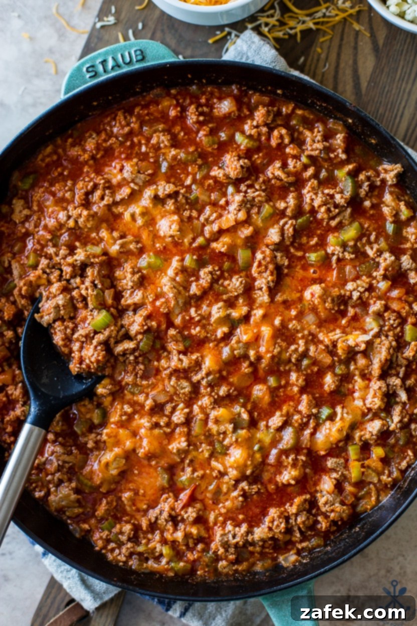 Spicy Buffalo Sloppy Joes 3 Up close overhead photo of a skillet of ground turkey meat with buffalo sauce, simmering to perfection.