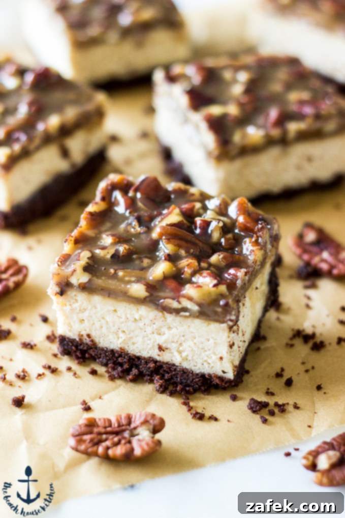 Decadent Pecan Praline Cheesecake Bars - A close-up of a square slice with creamy filling and nutty topping