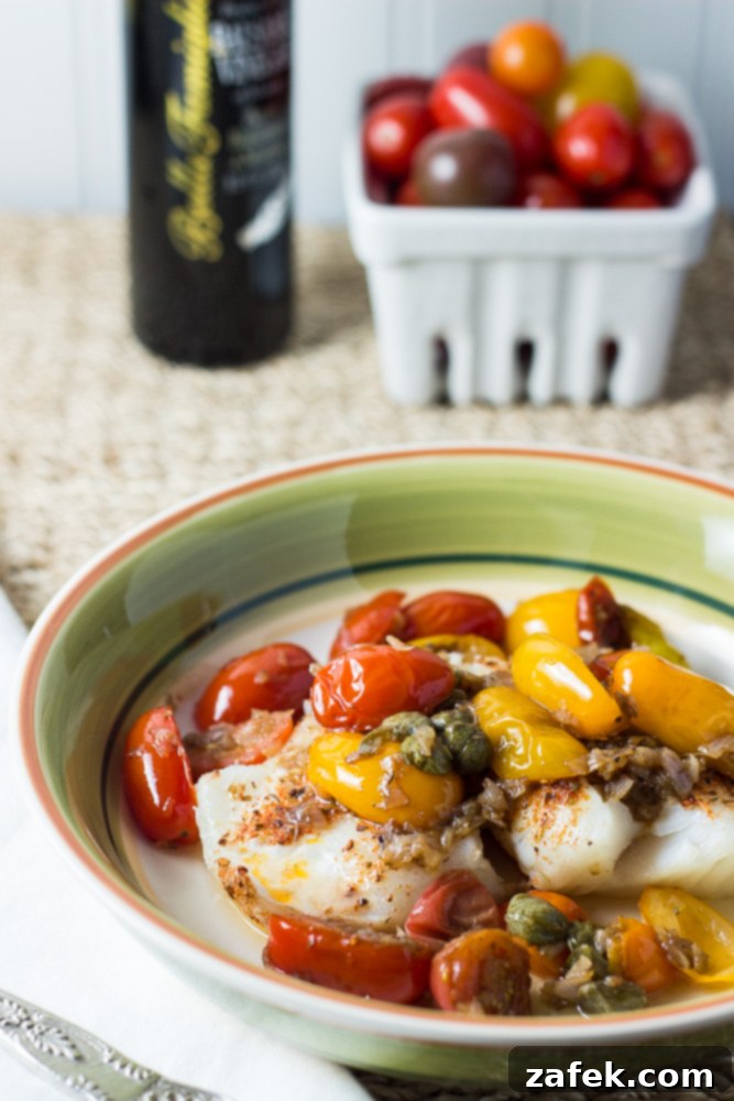 Delicious Striped Bass Fillets with vibrant Tomatoes and Capers sauce, ready to serve.