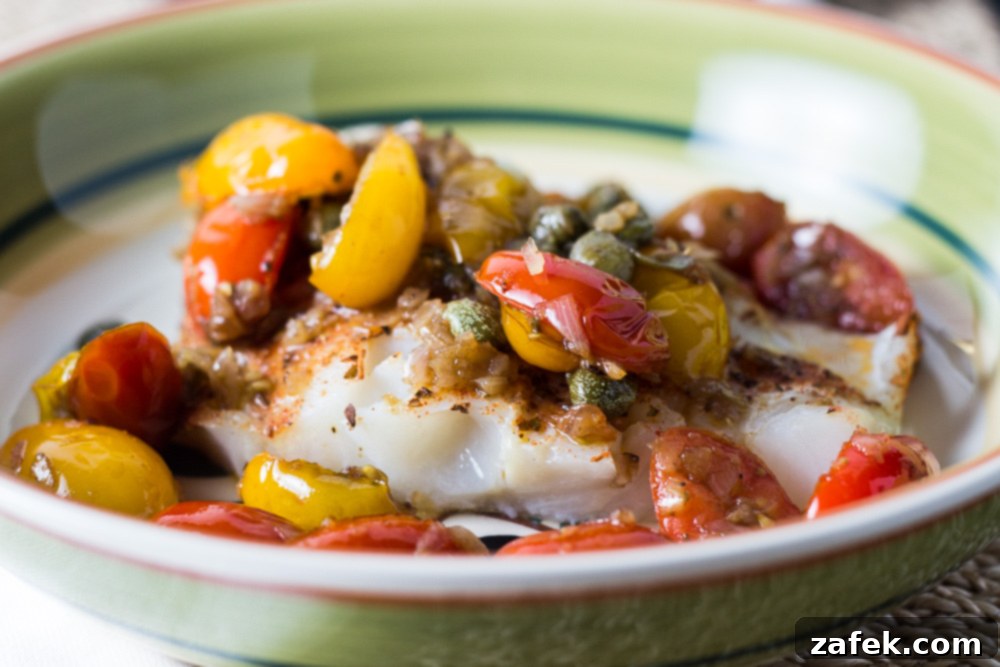 Perfectly cooked Striped Bass Fillets, garnished with fresh tomato and caper relish.