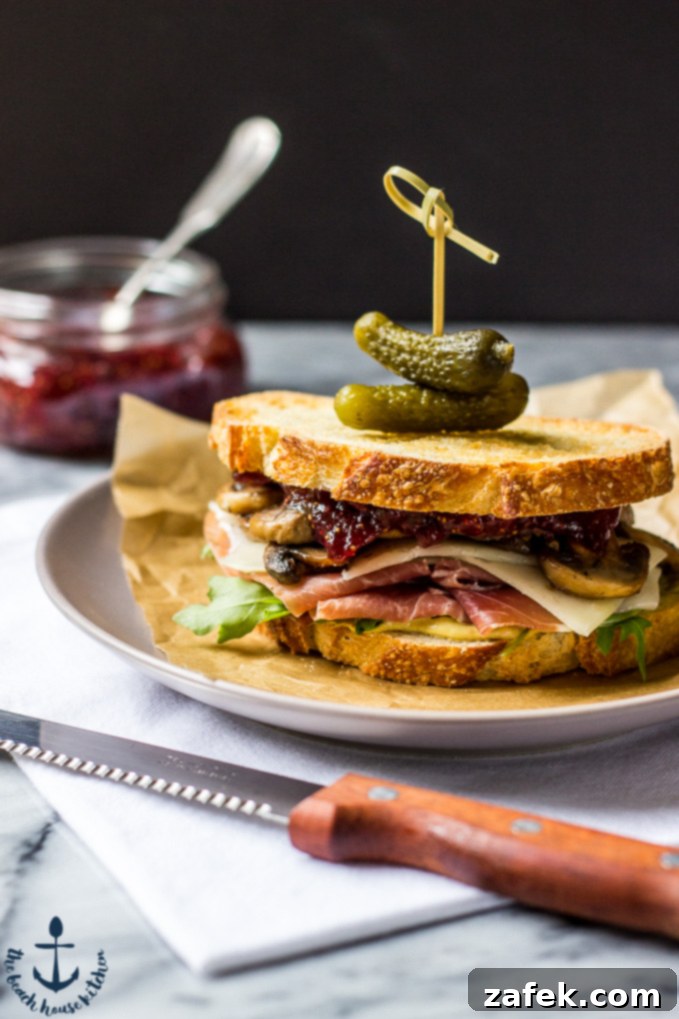 Close-up of the assembled Prosciutto and Asiago Sandwich with Marsala Mushrooms and Fig Jam
