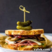 Final plating of Prosciutto and Asiago Sandwich with Marsala Mushrooms and Fig Jam
