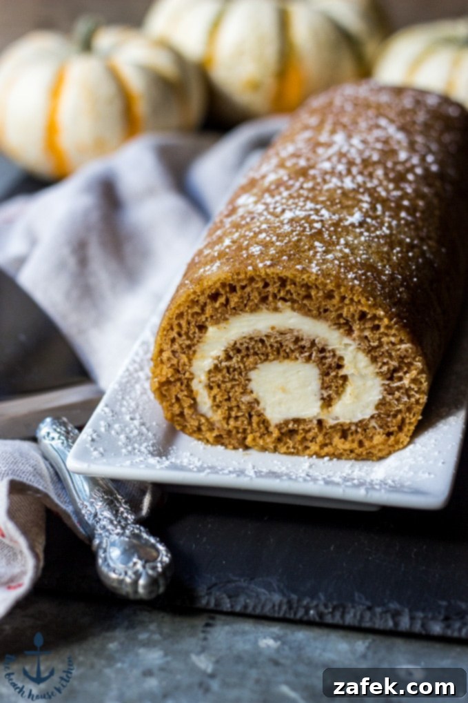 Spiced Pumpkin Swirl 4 Another view of the Pumpkin Roll, beautifully garnished with extra powdered sugar, ready for serving at a fall party.