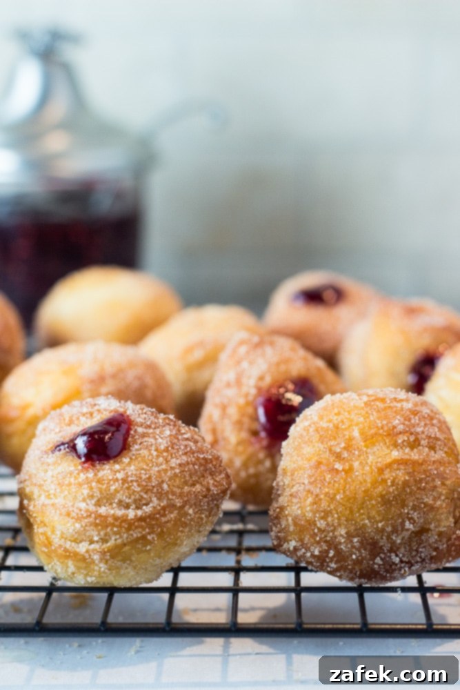 Miniature Donut Delights 3 A close-up of a tray filled with various donut bites, some glazed, some sugared.