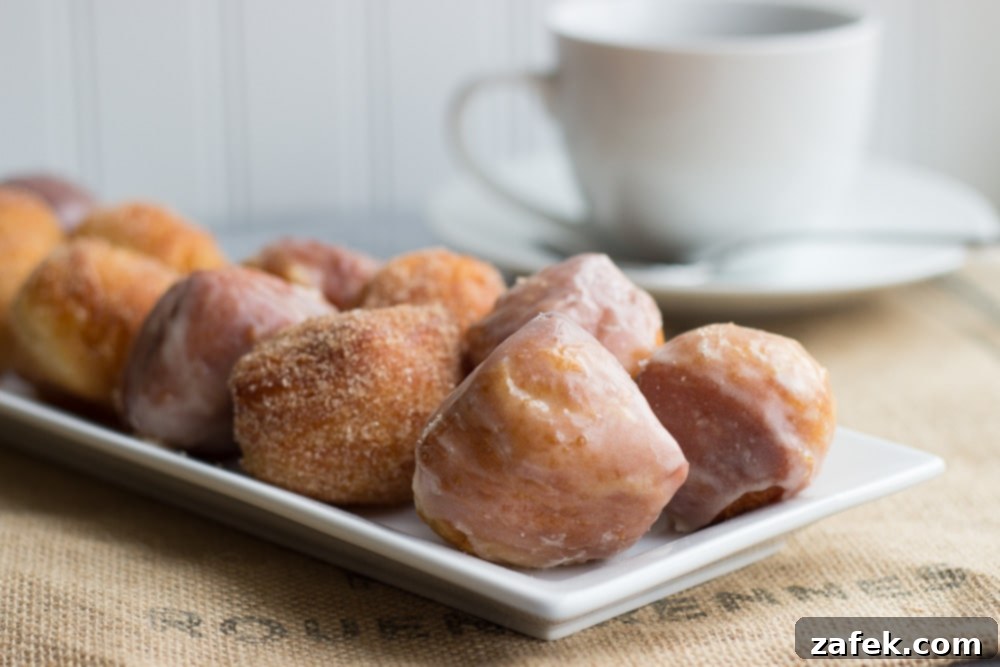 Miniature Donut Delights 4 A selection of mini donuts, some plain, some filled, on a rustic wooden surface.