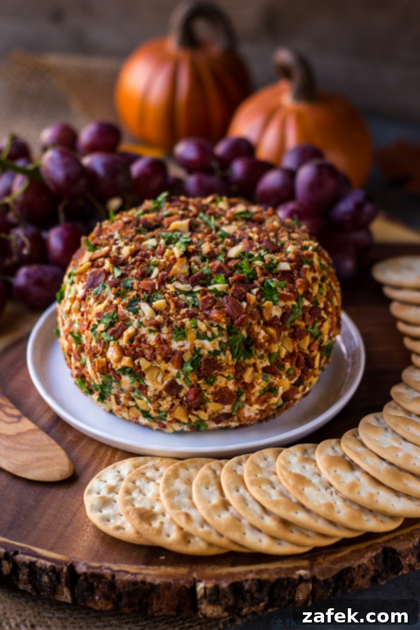 A vibrant Jalapeño Bacon Ranch Cheese Ball on a small white plate, surrounded by an assortment of crackers and fresh herbs, ready for serving.