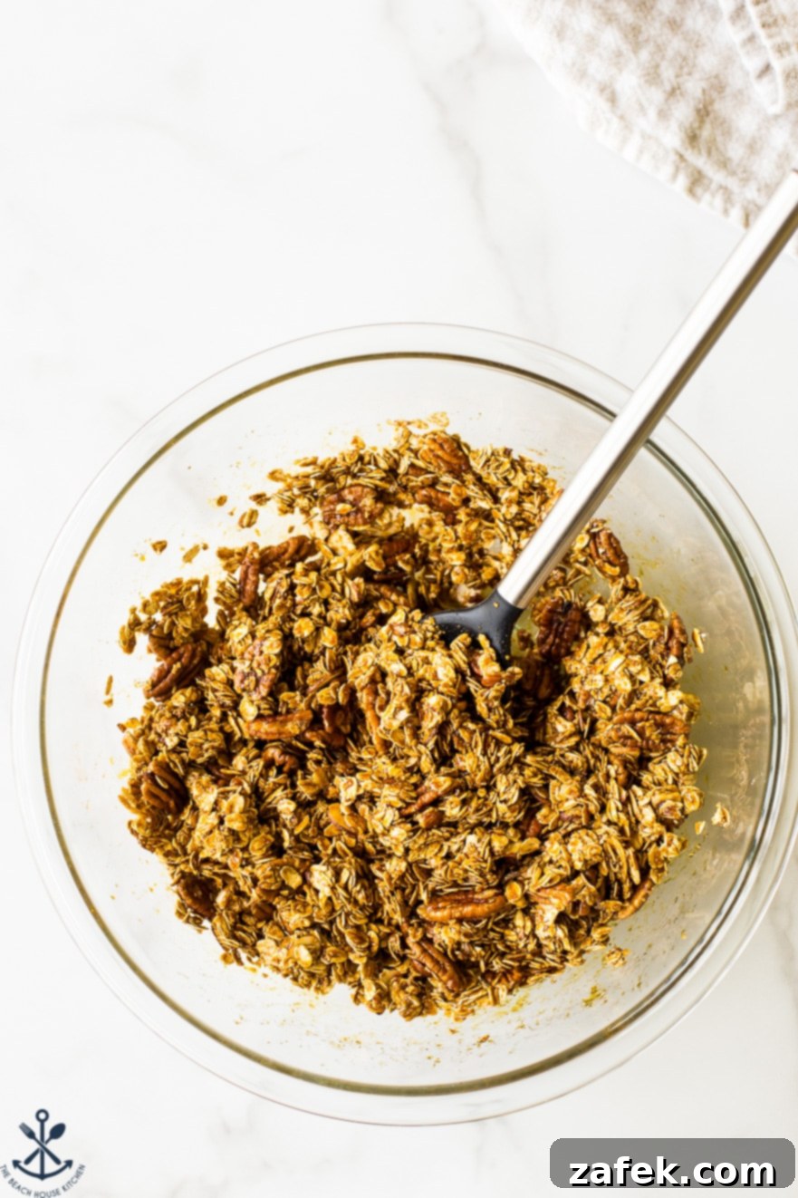 Overhead photo of glass bowl filled with maple cinnamon granola