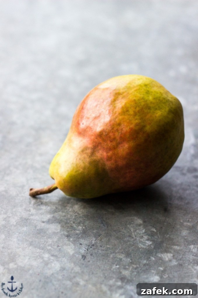 Pear-Cranberry-Bourbon-Chutney A pear on a silver background.