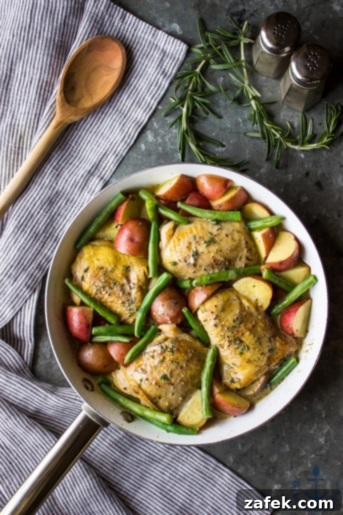 Skillet Mustard Chicken garnished with fresh herbs, ready for serving