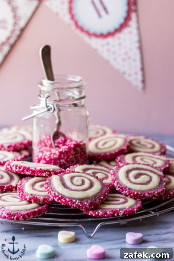 Sweetheart Raspberry Swirls 4 Beautifully arranged Valentine's Raspberry Pinwheel Cookies on a serving plate