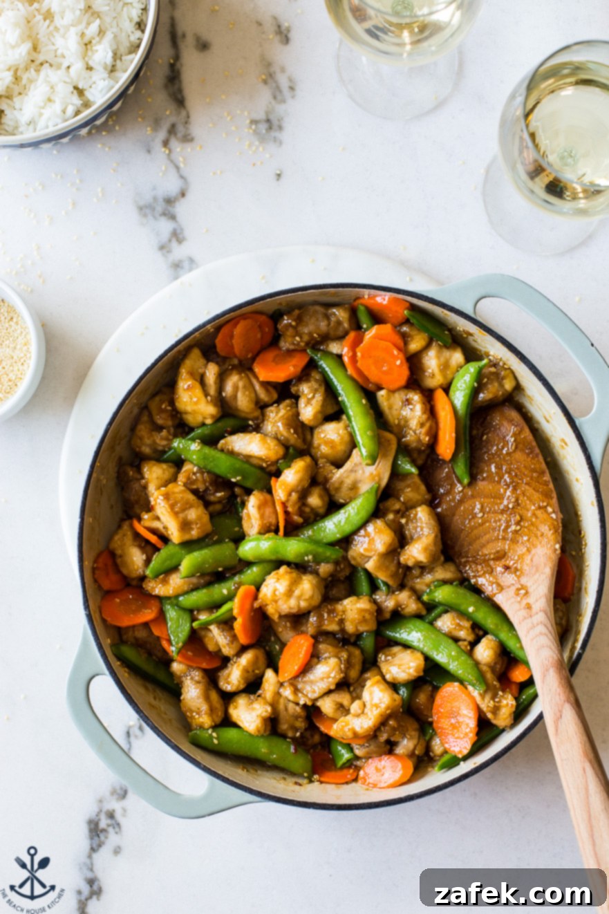 Effortless Sticky Sesame Chicken 5 Overhead view of a skillet filled with savory Easy Sesame Chicken, showcasing its rich glaze and inviting texture.