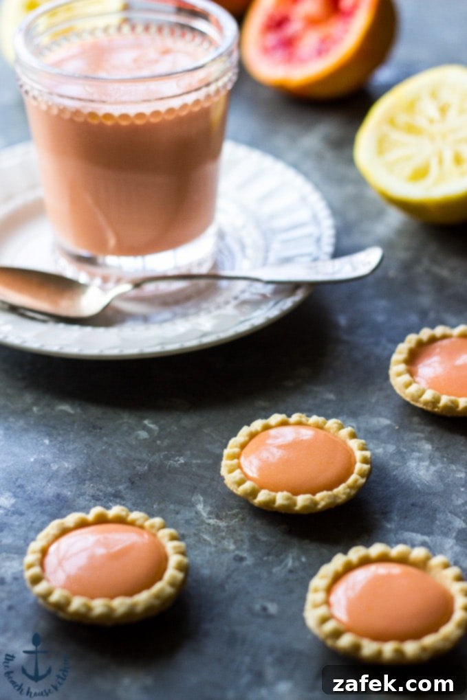 Sun-Kissed Ruby Curd 3 Individual servings of Blood Orange Curd in mini shortbread tart shells, arranged beautifully on a plate