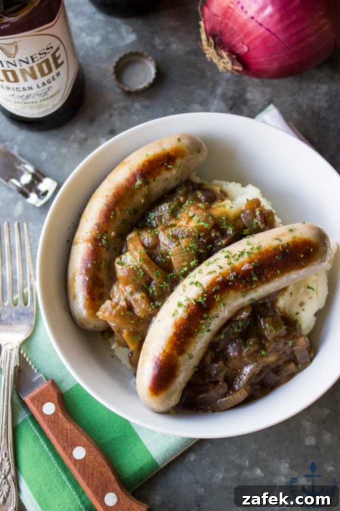 Guinness Onion Gravy Elevates Bangers and Mash 2 Bangers & Mash with Guinness Onion Gravy, served with creamy mashed potatoes