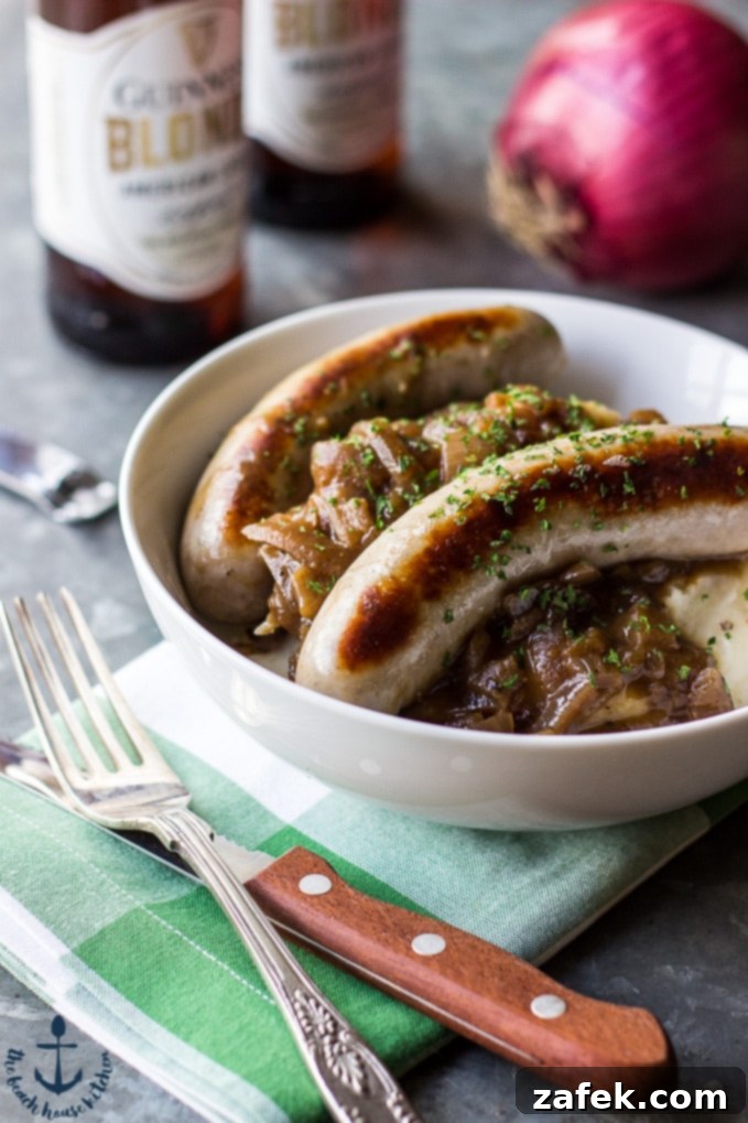 Guinness Onion Gravy Elevates Bangers and Mash 4 A plate of Bangers & Mash with Guinness Onion Gravy, garnished with fresh herbs