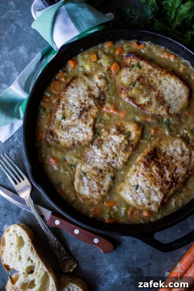 Homestyle Southern Smothered Pork Chops 3 Close-up of Southern Smothered Pork Chops in a skillet