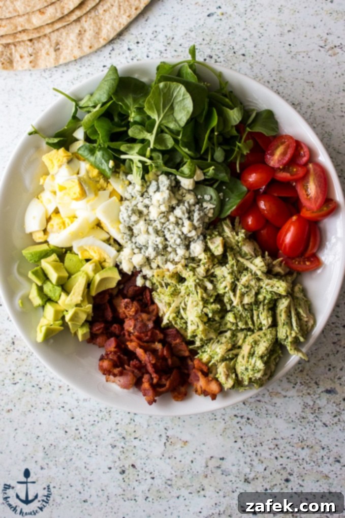 Gourmet Cobb Flatbread Wrap with Signature Watercress Pesto 3 Close-up of a perfectly wrapped Cobb Salad Flatbread, showing the rich ingredients and creamy pesto