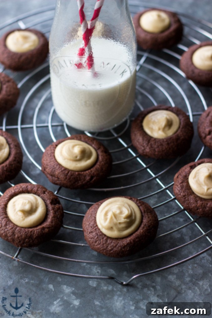 Close-up of a stack of Chocolate Peanut Butter Thumbprint Cookies with a delicate peanut butter filling, showcasing the rich chocolate cookie base.