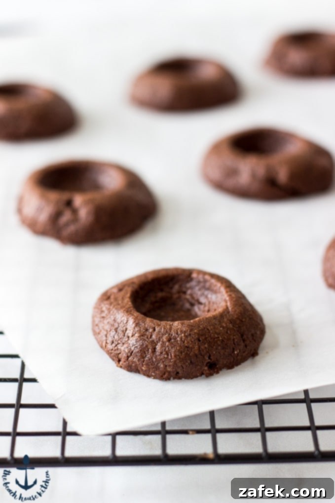 A delicious Chocolate Peanut Butter Thumbprint Cookie with a soft, inviting peanut butter center, ready to be enjoyed.