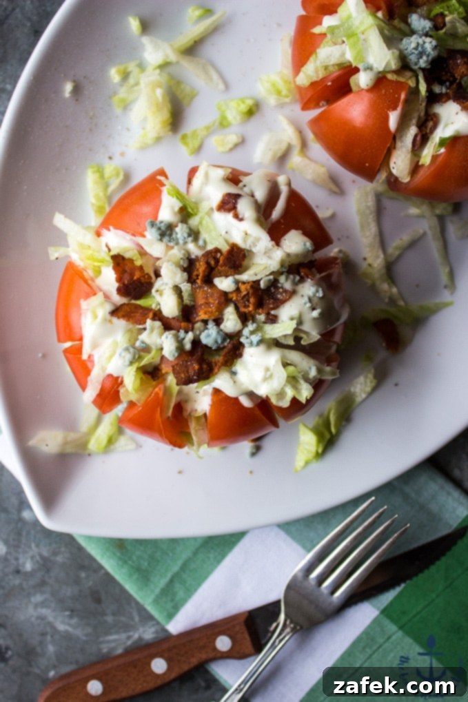 Savory Stuffed Tomatoes 3 Two Stuffed Tomatoes on a plate, garnished with fresh herbs and ready to serve, highlighting their colorful layers.