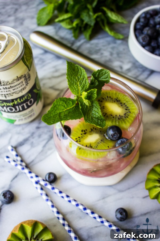 Zesty Berry Kiwi Mojito 2 Vibrant Blueberry Kiwi Mojito in a glass with fresh fruit garnish.