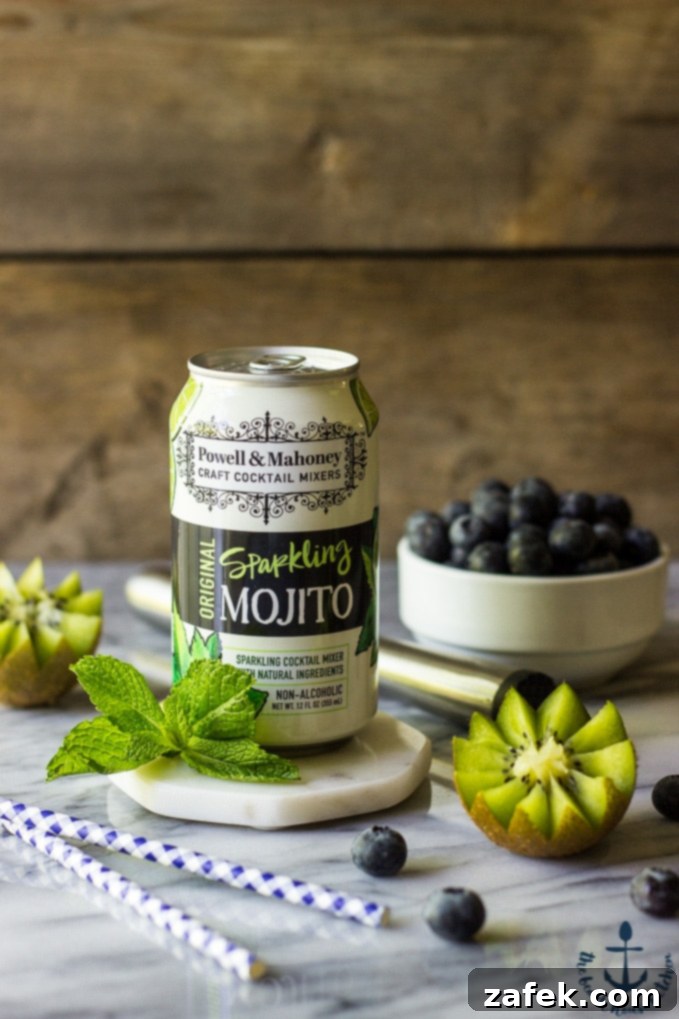 Zesty Berry Kiwi Mojito 4 Ingredients for a Blueberry Kiwi Mojito laid out, including a can of Powell & Mahoney mixer.