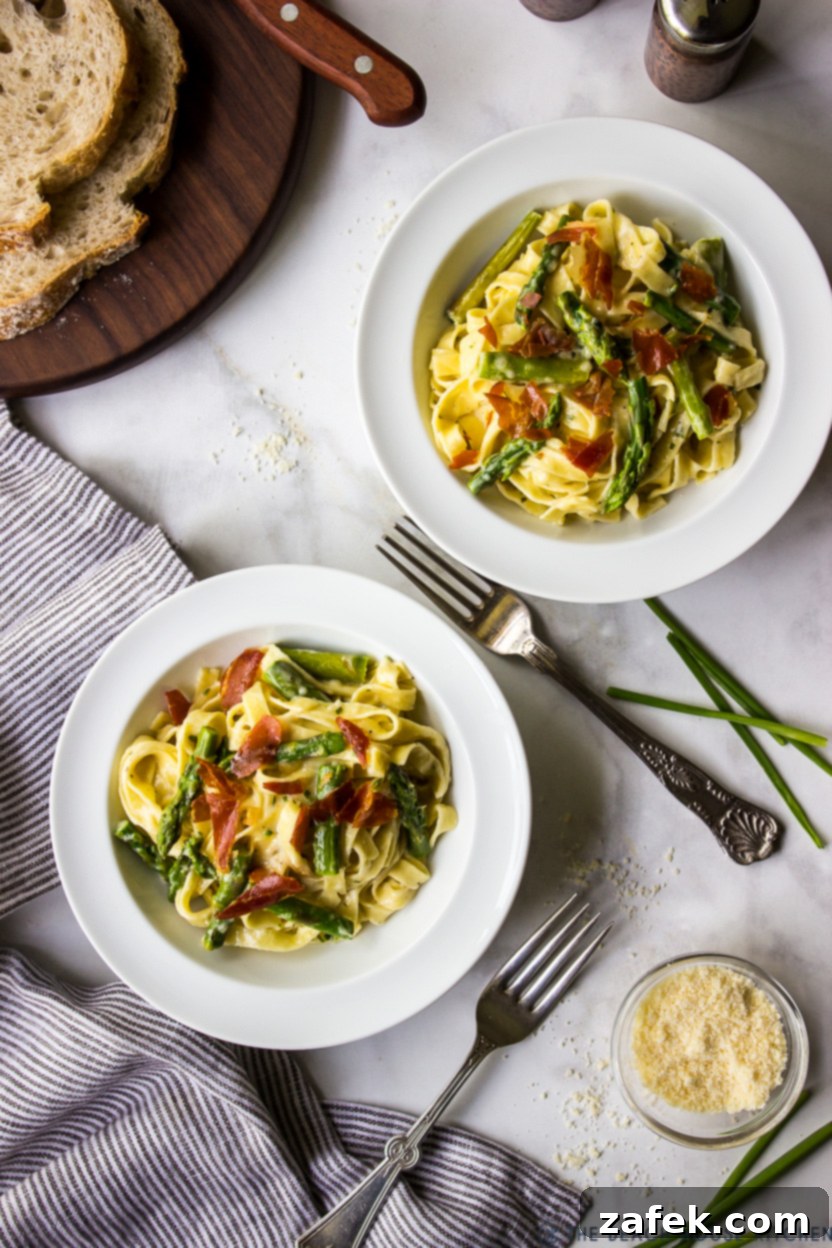 Crispy Prosciutto and Tender Asparagus Fettuccine Alfredo 2 Overhead photo of two bowls of Creamy Fettuccine Alfredo with Asparagus and Crispy Prosciutto, garnished and ready to serve