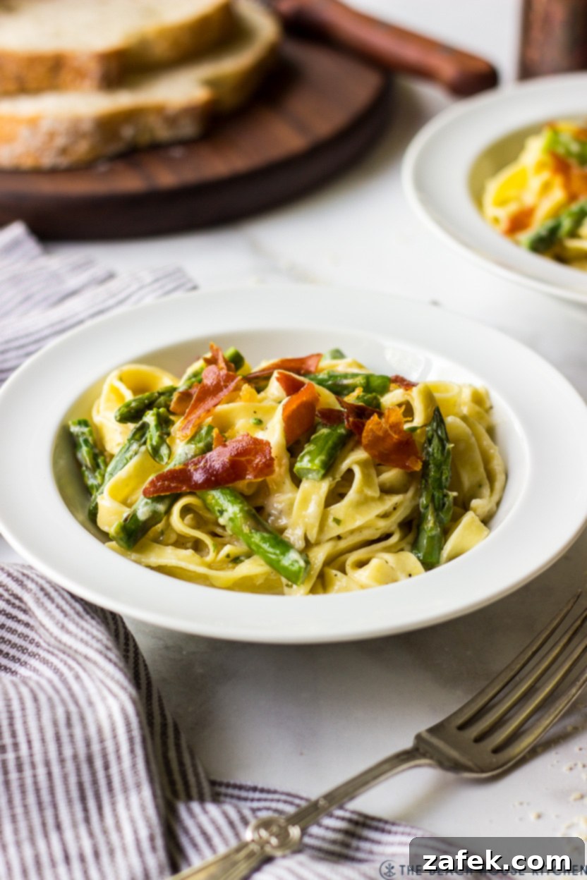 Crispy Prosciutto and Tender Asparagus Fettuccine Alfredo 4 Photo of a single bowl of pasta with asparagus and crispy prosciutto, ready to be enjoyed