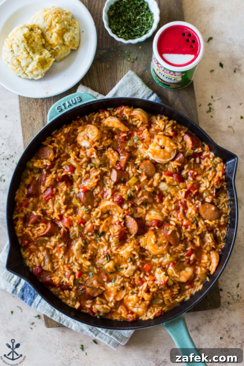 Bayou Jambalaya 9 Overhead photo of a skillet of jambalaya with two biscuits on a plate off to the side