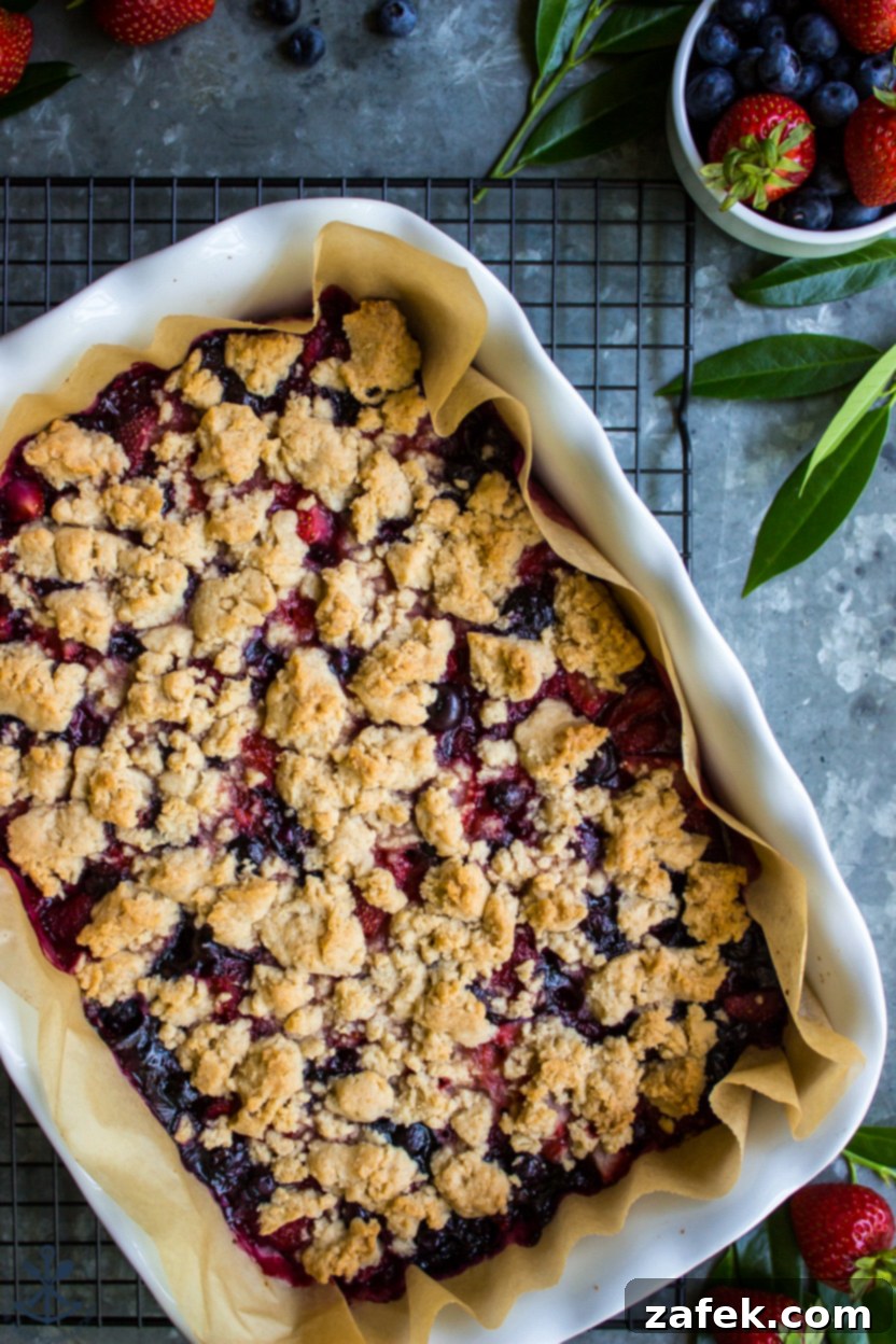 Summer Berry Streusel Bars 3 Overhead photo of a baking dish filled with fruit bars topped with a golden-brown crumb, ready to be cooled.