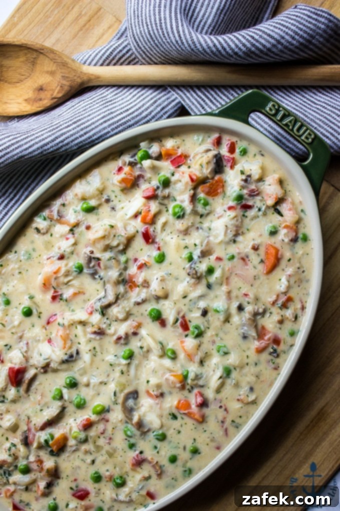 Fisherman's Pie 4 Inside the Seafood Pot Pie – A scoop reveals shrimp, crab, and vegetables in a creamy sauce, topped with tater tots.