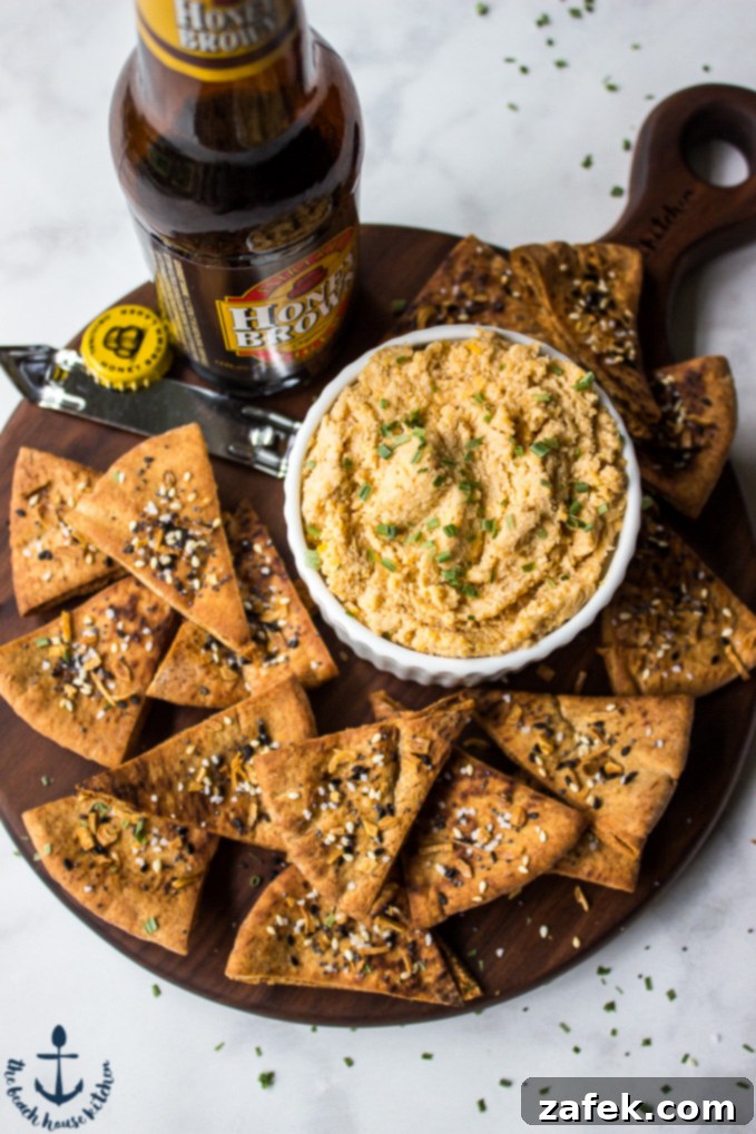 Creamy Cheddar Pub Cheese and Zesty Everything Pita Chips 2 Cheddar Pub Cheese with Everything Pita Chips, a perfect appetizer for unexpected guests.