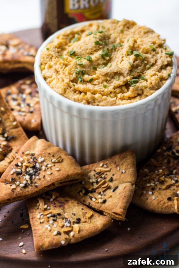 Creamy Cheddar Pub Cheese and Zesty Everything Pita Chips 3 Close-up of creamy Cheddar Pub Cheese ready to be served, emphasizing its smooth texture.