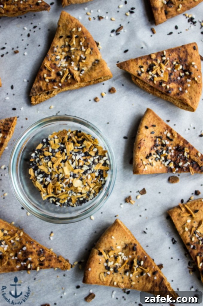 Creamy Cheddar Pub Cheese and Zesty Everything Pita Chips 4 Serving bowl filled with Cheddar Pub Cheese, garnished with fresh chives, ready for dipping.