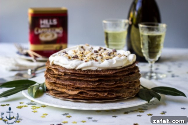 Double-Chocolate-Hazelnut-Crepe-Cake Double Chocolate Hazelnut Crepe Cake positioned centrally on a white serving platter. The background features champagne glasses, a celebratory bottle, and a Hills Bros. coffee can, indicating a festive setting.