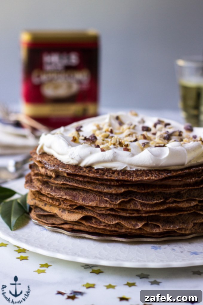 Double-Chocolate-Hazelnut-Crepe-Cake A majestic Double Chocolate Hazelnut Crepe Cake showcased on a white platter, with a Hills Bros. coffee can subtly visible in the background, hinting at the inspiring ingredient.