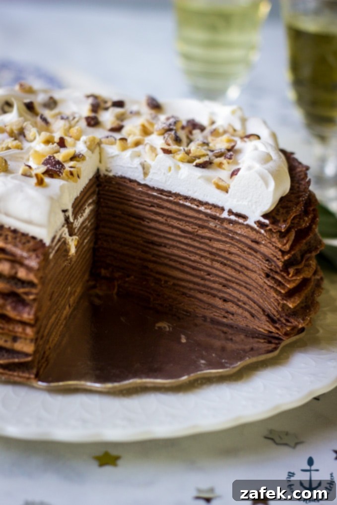 Double-Chocolate-Hazelnut-Crepe-Cake A detailed close-up shot revealing the beautiful, delicate layers of the Double Chocolate Hazelnut Crepe Cake, highlighting the thin chocolate crepes and rich hazelnut mousse filling.