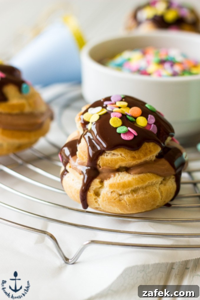 Nutella-Cream-Puffs Close up of Nutella Cream Puffs drizzled with chocolate and topped with colored sprinkles