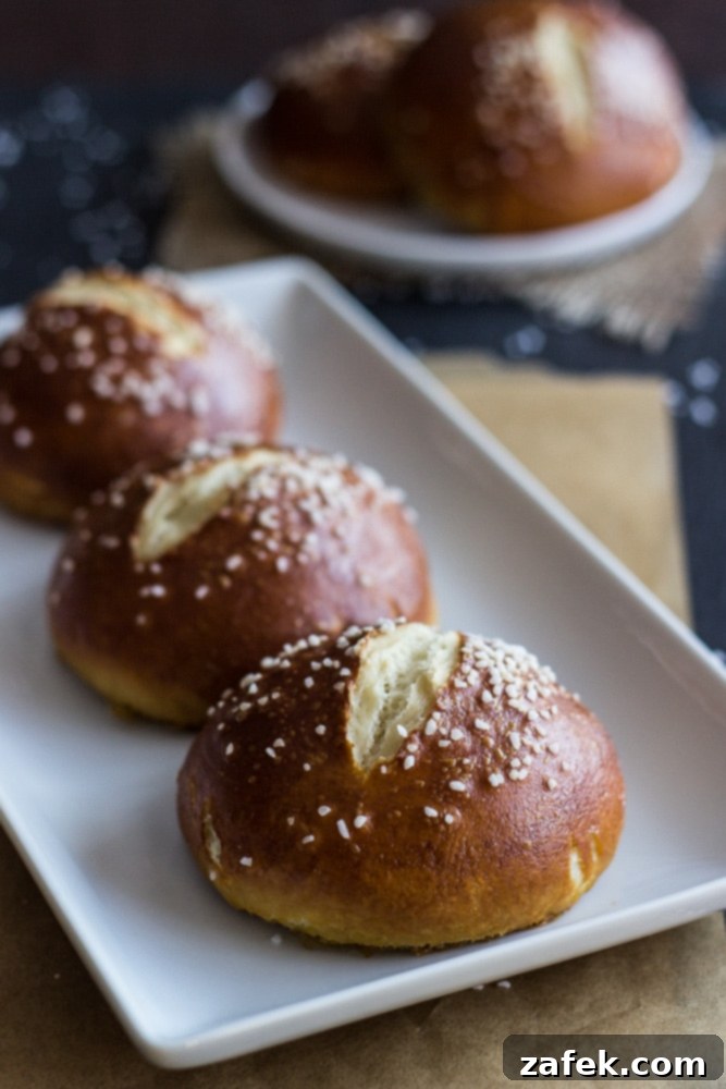 Soft Pretzel Buns 5 A charming basket filled with an assortment of freshly baked pretzel rolls, ready for serving at a family meal or gathering.