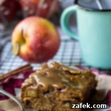 Caramel Glazed Apple Butter Blondie on a red and white check plate with an apple and green mug in background.