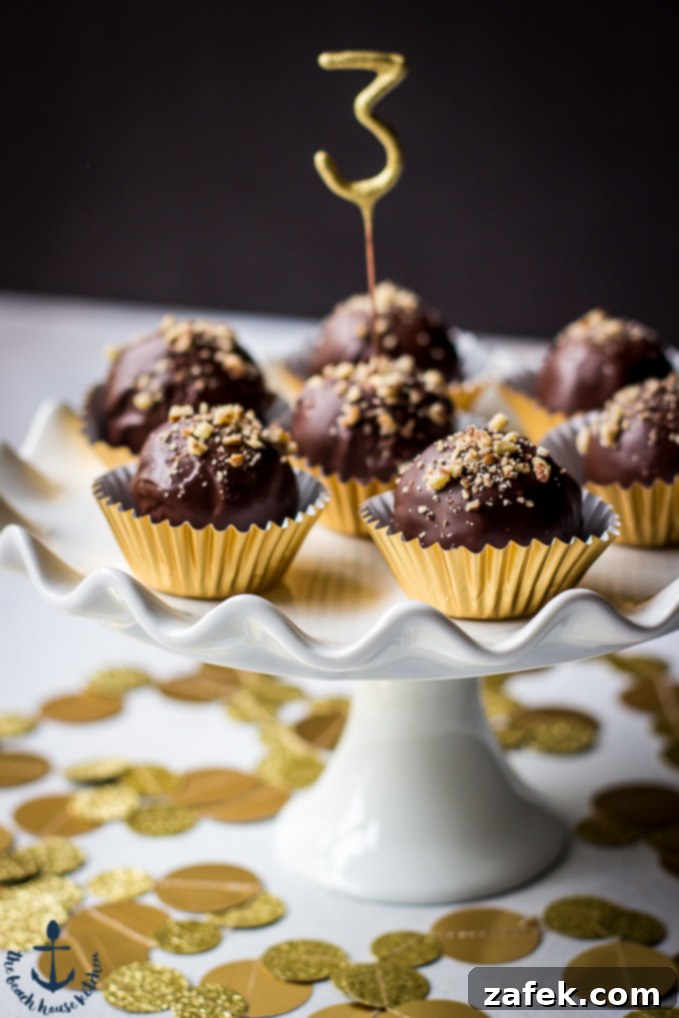 Decadent Pecan Pie Truffles in gold cups on a white cake pedestal, ready for holiday celebrations.