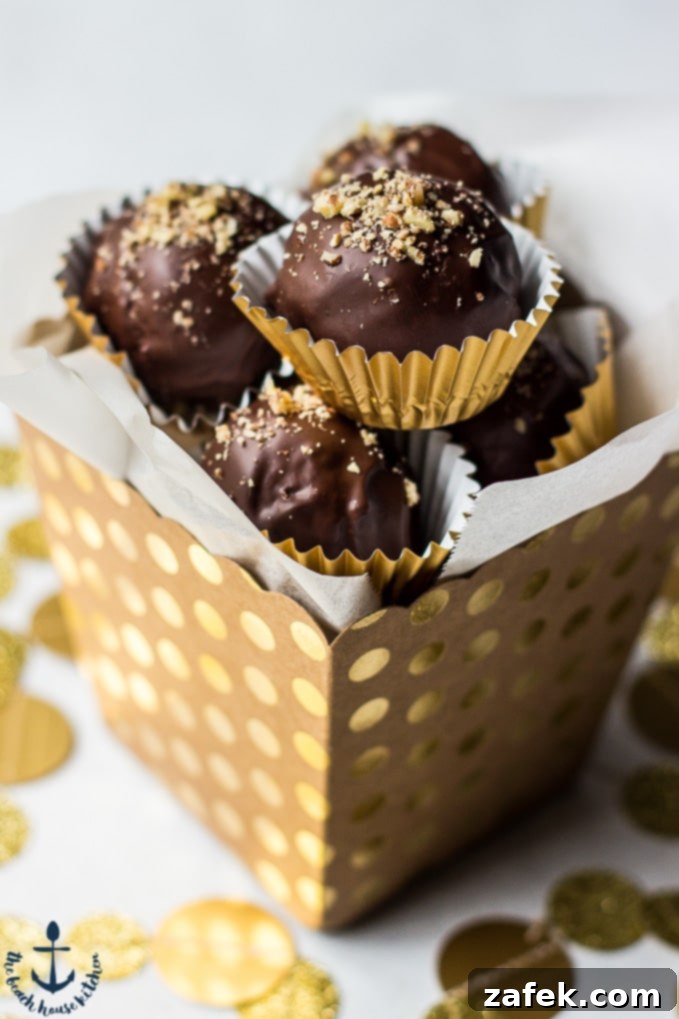 Homemade Pecan Pie Truffles beautifully packaged in a gold polka dot cardboard box, ideal for thoughtful holiday gifting.