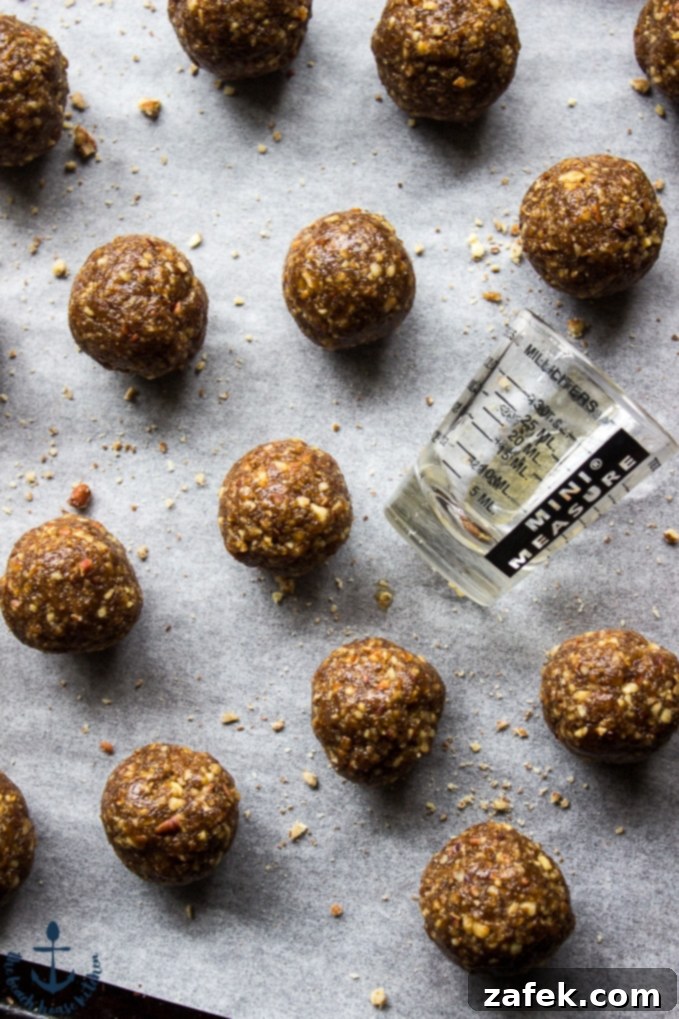 Uncoated Pecan Pie Truffle mixture balls on parchment paper, ready for their chocolate dip.