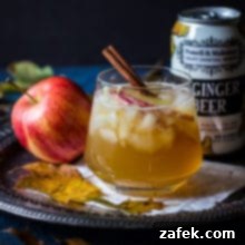 The Tempestuous Fall 2 The Fall Dark and Stormy cocktail with apple slices and a cinnamon stick.