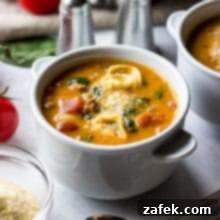 Overhead photo of a large Dutch oven filled with the mouthwatering tomato tortellini stew, ready to be served.