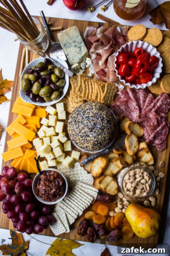 Epic Fall Cheese Board with Everything Cheddar Horseradish Cheese Ball A comprehensive view of the Epic Fall Cheese Board, beautifully arranged with the Everything Cheddar Horseradish Cheese Ball as its focal point, surrounded by an abundance of diverse ingredients.